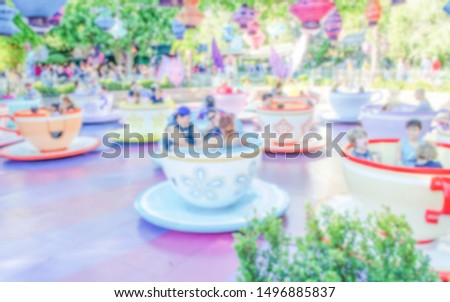 Defocused background of teacups attraction in amusement park. Intentionally blurred post production for bokeh effect
