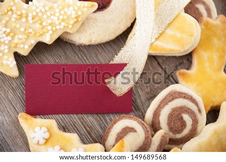 a background with christmas cookies and red label with copy space