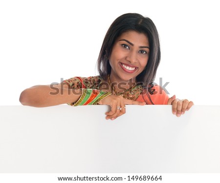 Traditional Indian woman in sari holding blank billboard. Portrait of attractive young Asian female model isolated on white background.