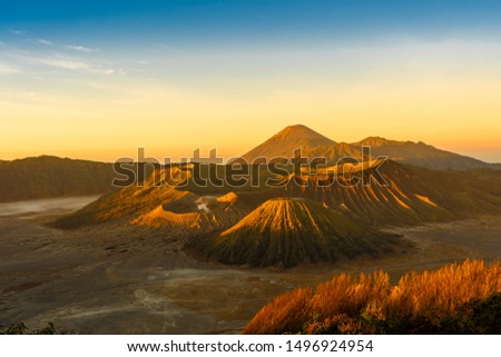 The bromo volcano on java in indonesia during the sunrise. This creates a nice warm light on the mountain