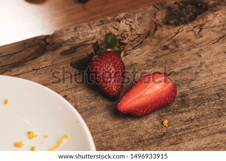 two strawberry fruits on  wood table background