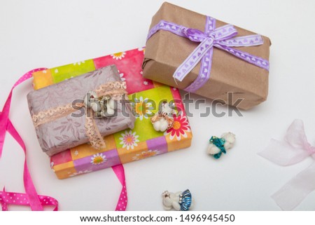 gifts in boxes on a white background place copy top view golden ribbon with bow wrapped in brown paper purple ribbon braid cute bears for decoration bright colorful