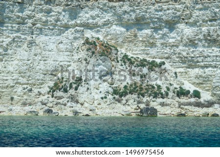 Beautiful view of us we are with the rocky shore of the black sea and the green-blue water on a Sunny summer cloudless day. Tarkhankut national reserve. Republic Of Crimea