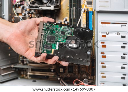 Closeup image of technician man hand changing the hard drive of pc computer . Maintenance and repair computer hardware service concept .