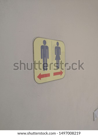 A sign to the bathroom for men and women