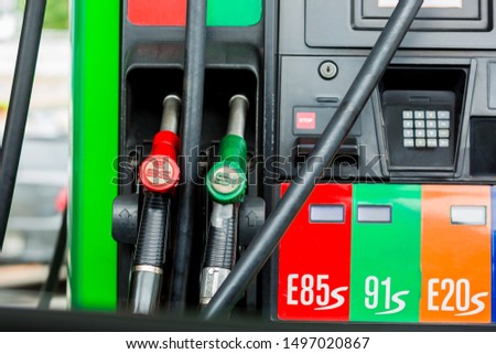 Gas pump nozzles in a service station, Close up fuel nozzles at gas station, Panel and Dashboard of fuel nozzles of E85 E20 and Gasohol 91. The concept of fuel energy. Royalty-Free Stock Photo #1497020867