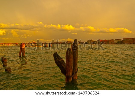 Venice Italy lagune view with "bricole" timber planted to sign the way of the canal