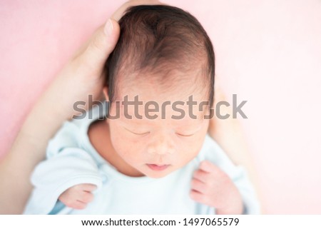 Newborn baby on mother's hand