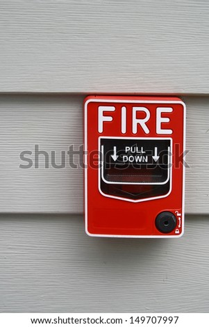fire alarm switch hang on gray wood wall background