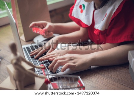 Mother and daughter shopping online. shopping, technology and people - happy with laptop computer and credit card.