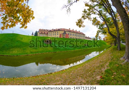The park around the Nesvizh castle, a view of the castle, a moat and defensive walls, shoots were taken in autumn fall on a fisheye lens.