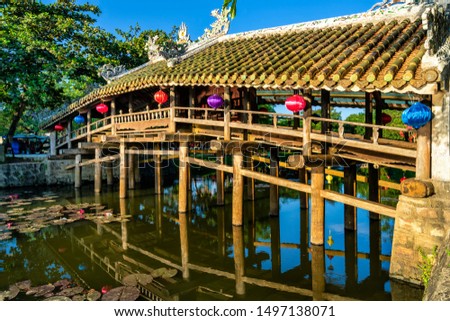 Wonderful view of the "Cau Ngoi Thanh Toan " or Thanh Toan tile bridge near Imperial City with the Purple Forbidden City within the Citadel in Hue, Vietnam. 
