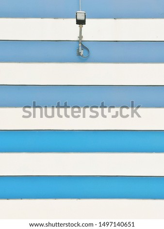 Lamp on the blue and white wall