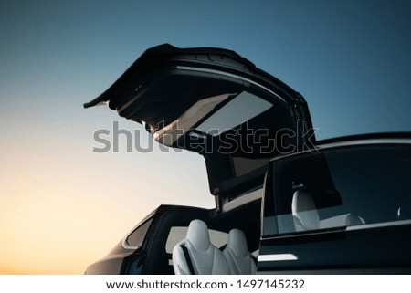 Modern and futuristic SUV car vertical door. Expensive and luxury crossover with falcon wings style door  Royalty-Free Stock Photo #1497145232