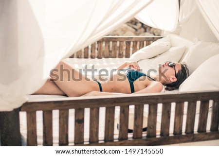Girl lie on a bed in the beach