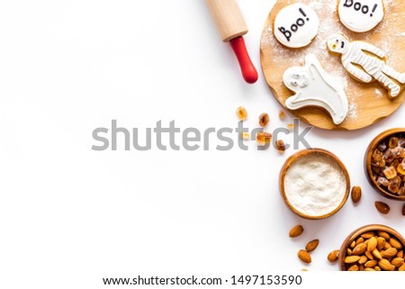Cooking creepy cookies concept with almonds, pin, flour on white background top view mock-up