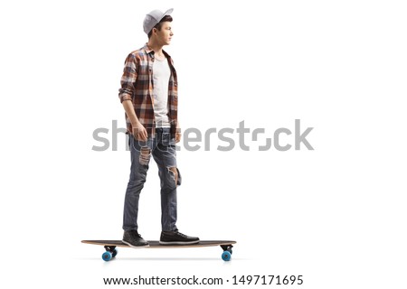 Full length shot of a male teenage skater on a longboard isolated on white background