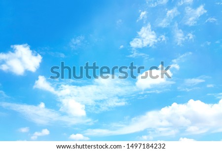 Light blue sky and white clouds. On a clear sky, floating clouds.
With copy space.