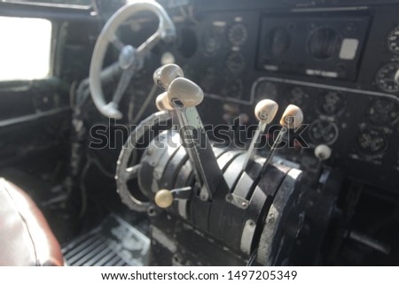 close up horizontal photography of inside of Ił plane cockpit, with steering wheels and levers, with natural light, in Poland, Europe