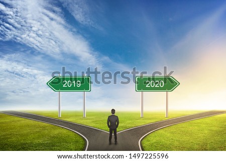 Businessman Concept of choose the correct way. Between 2019 or 2020 years.
