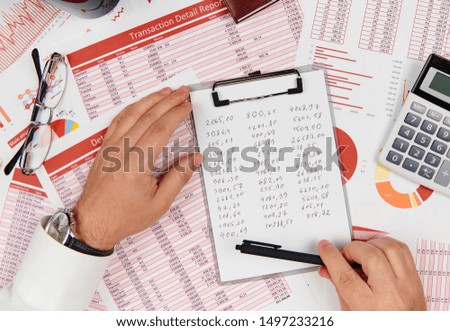Flat top view of businessman working and calculating finance, reads and writes reports. Business financial accounting concept.