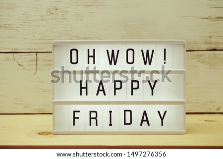 Happy Friday text in lightbox with space copy on wooden background