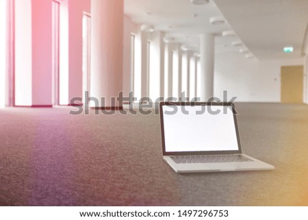 Photo of laptop on the floor in empty office