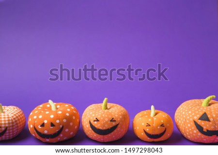 Halloween soft happy pumpkins on a purple background