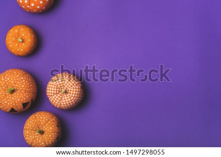 Halloween fluffy orange pumpkins on a purple background