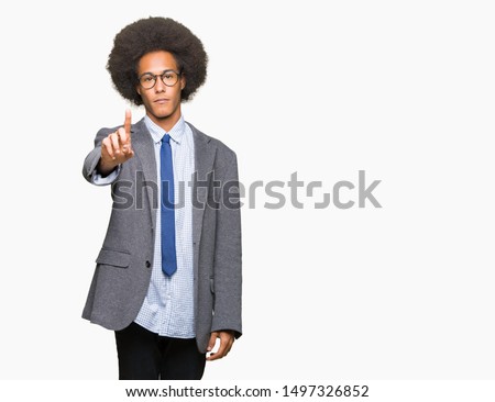 Young african american business man with afro hair wearing glasses Pointing with finger up and angry expression