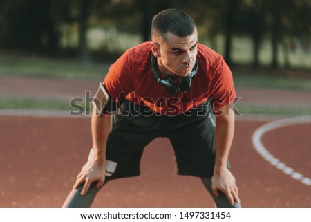 Young athlete stretching his legs outdoors