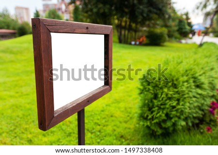 wooden plate on a green lawn, copy space