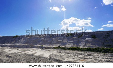 
industry extraction of white sand, a mountain of white sand laid by an excavator. sand block structure