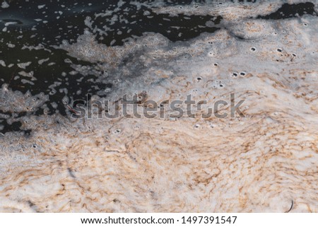 Pollution of river or lake. Organic scum foaming in the water. Environment in danger concept. Dangerous pond. Royalty-Free Stock Photo #1497391547