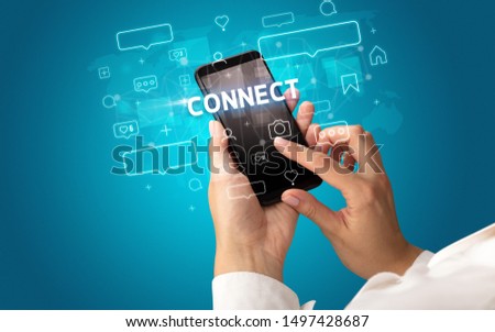 Female hand typing on smartphone with CONNECT inscription, social media concept