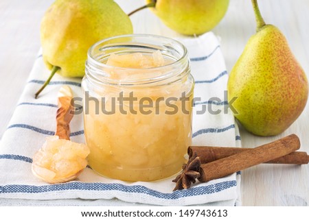 Homemade pear jam in jar on background fresh ripe pears