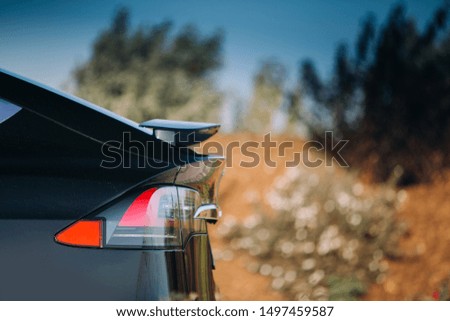 Modern car active aerodynamic wing spoiler at the trunk of electric suv Royalty-Free Stock Photo #1497459587