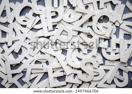 Mixed solid letters pile top view photo. Education background concept