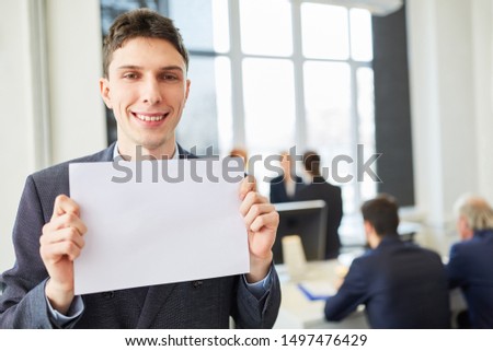 Young business man holds empty sign for marketing presentation