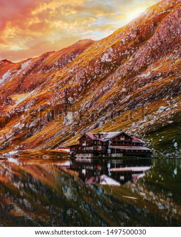 Bâlea Lake in the Făgăraș Mountains, Sibiu County. Reflection of the cottage in the water of the lake at sunset. Picture taken on August 30th, 2019.