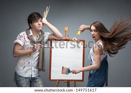 man and woman painters emotionally discussing art project
