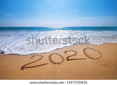 Happy New Year 2020 is coming concept sandy tropical ocean beach lettering. Exotic New Year celebration concept image. Royalty-Free Stock Photo #1497530426