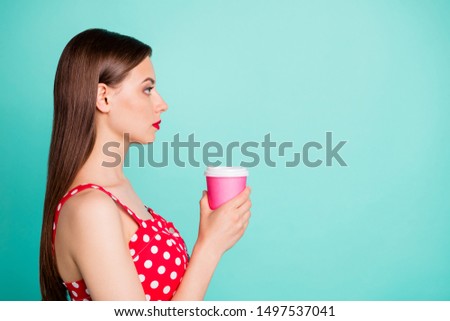 Profile side photo of  charming youth in polka-dot dress skirt looking holding mug isolated over teal turquoise background