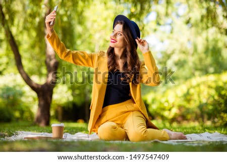 Portrait of her she nice-looking attractive lovely charming gorgeous pretty trendy cheerful cheery wavy-haired girl sitting on cover taking making selfie on fresh air outdoors