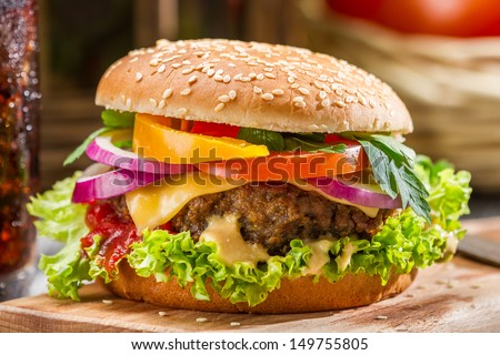 Closeup of homemade hamburger with fresh vegetables Royalty-Free Stock Photo #149755805