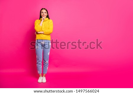 Full size photo of minded lady touching her chin looking having thoughts wearing knitted jumper dotted denim jeans isolated over fuchsia background