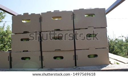 folded boxes with apples. on a tractor trailer Royalty-Free Stock Photo #1497569618