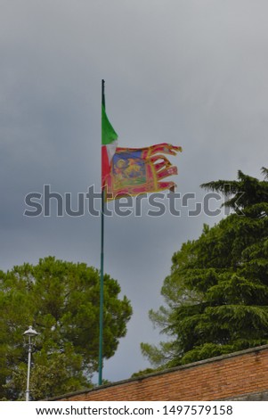 Flag of Italy and Veneto region, cloudy day