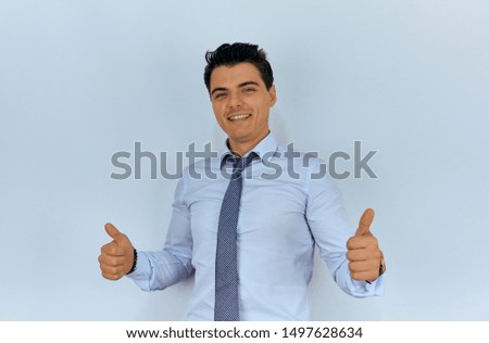 Young and  handsome businessman making victory sign with fingers