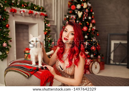 woman in christmas interior with white cat